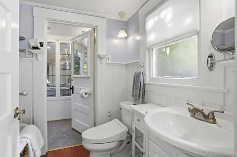 a bathroom with a toilet sink and shower