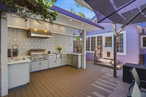 a kitchen with stove and wooden floor