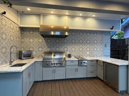 a kitchen with kitchen island a sink stainless steel appliances and cabinets