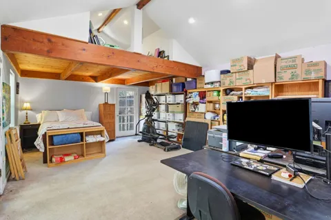 a bedroom with furniture and a flat screen tv