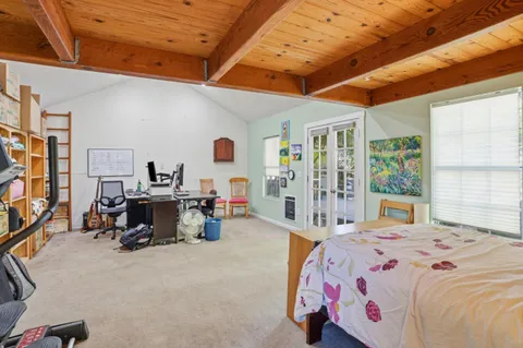 a bedroom with furniture and a large window