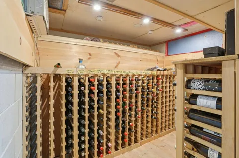 a view of walk in closet with wooden floor