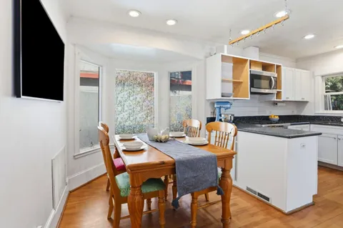 a view of a dining room with furniture and wooden floor