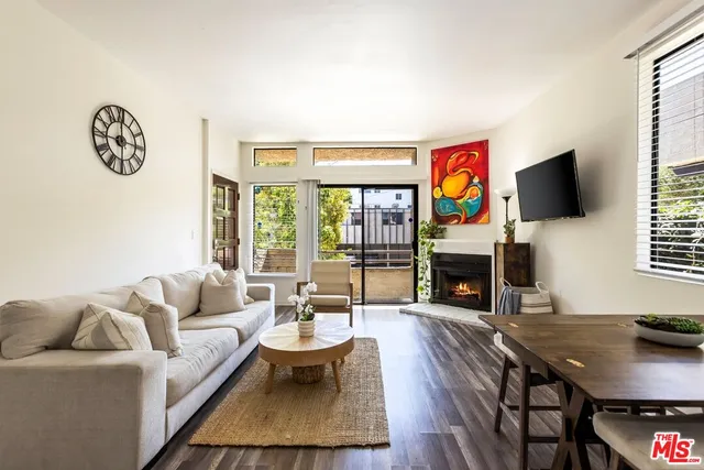 a living room with fireplace furniture and a flat screen tv