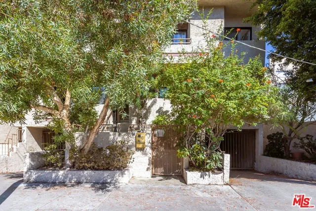 a tall building with trees in front of it