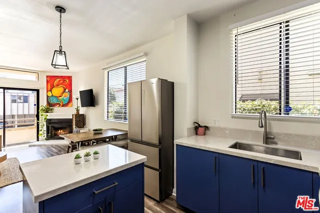 a kitchen with a refrigerator a sink and a stove