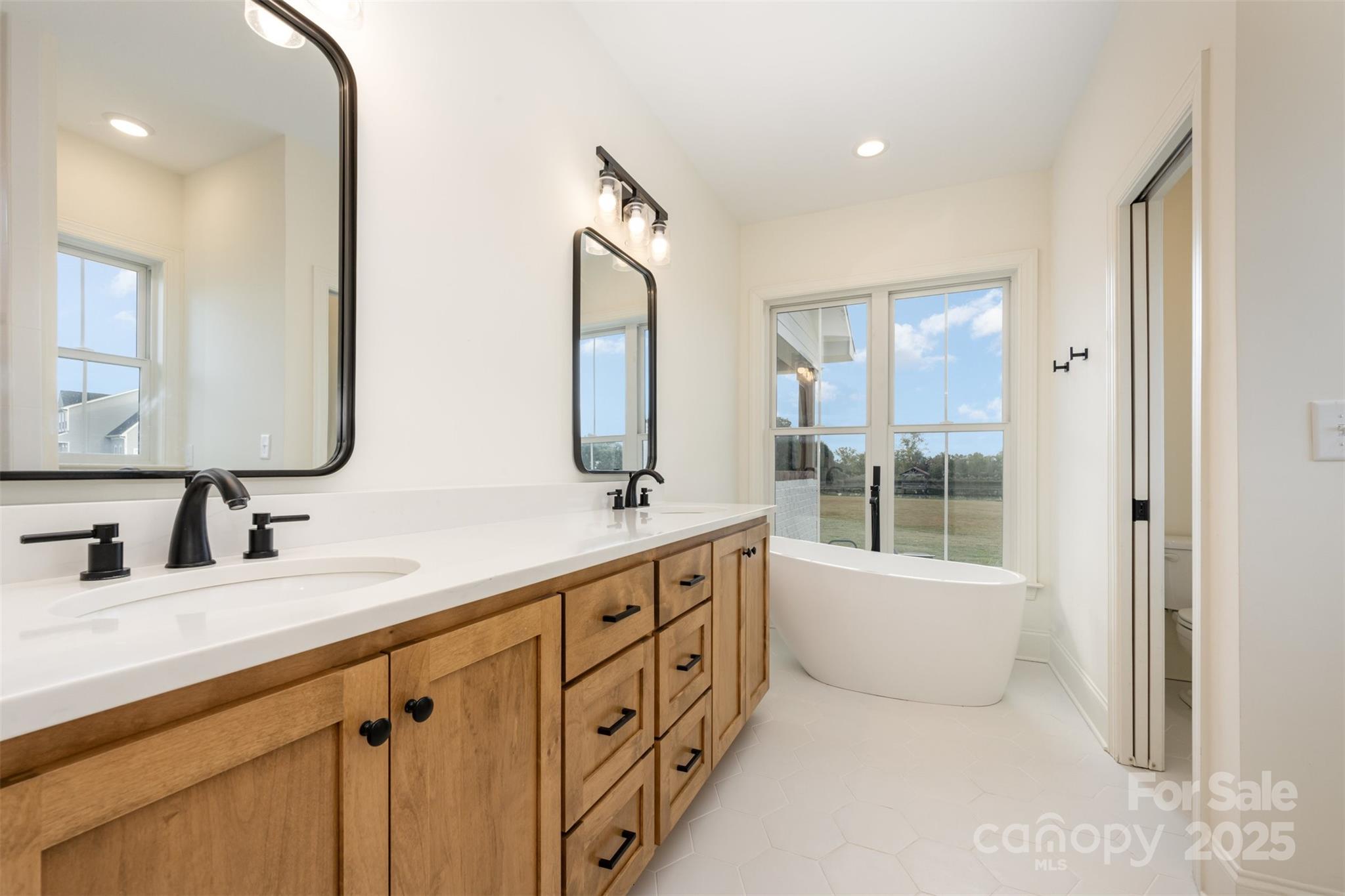 6322 Olive Branch Road Marshville, NC 28103 - Photo 12 of 28 a bathroom with a tub sink and mirror