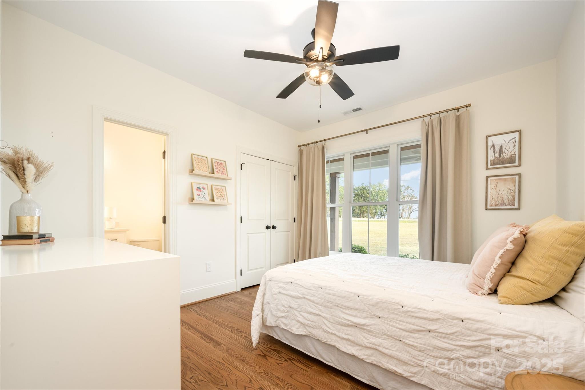 6322 Olive Branch Road Marshville, NC 28103 - Photo 13 of 28 a bedroom with a bed and a chandelier