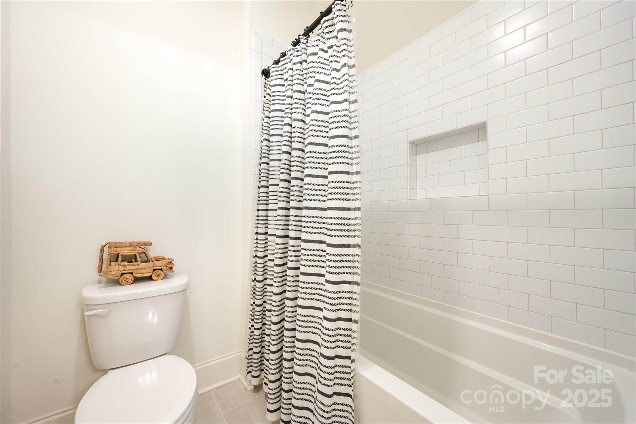 6322 Olive Branch Road Marshville, NC 28103 - Photo 17 of 28 a white toilet sitting next to a bath tub