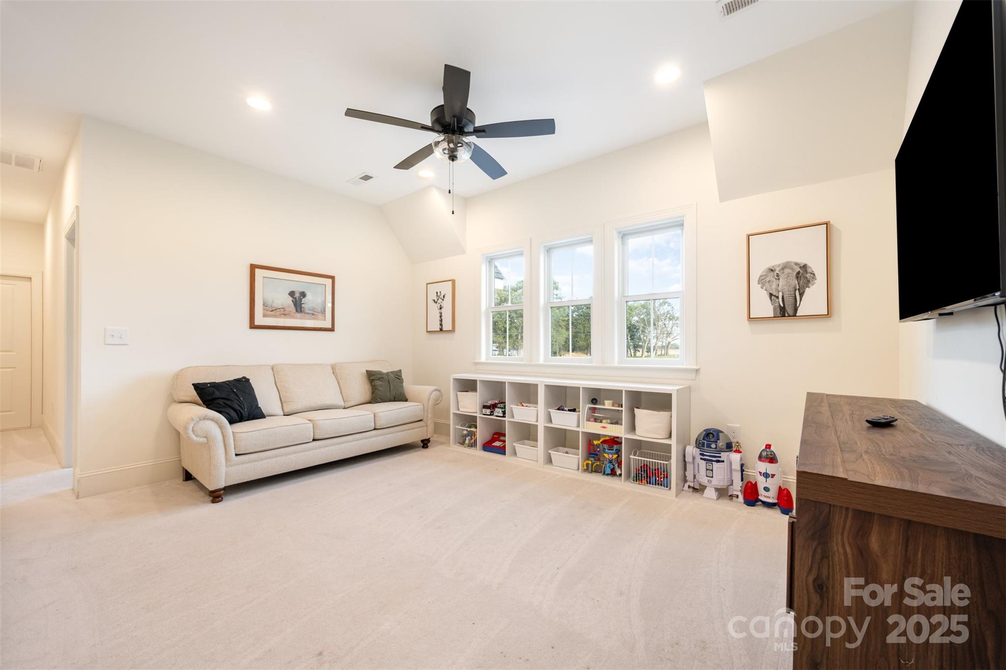 6322 Olive Branch Road Marshville, NC 28103 - Photo 19 of 28 a living room with furniture and a flat screen tv