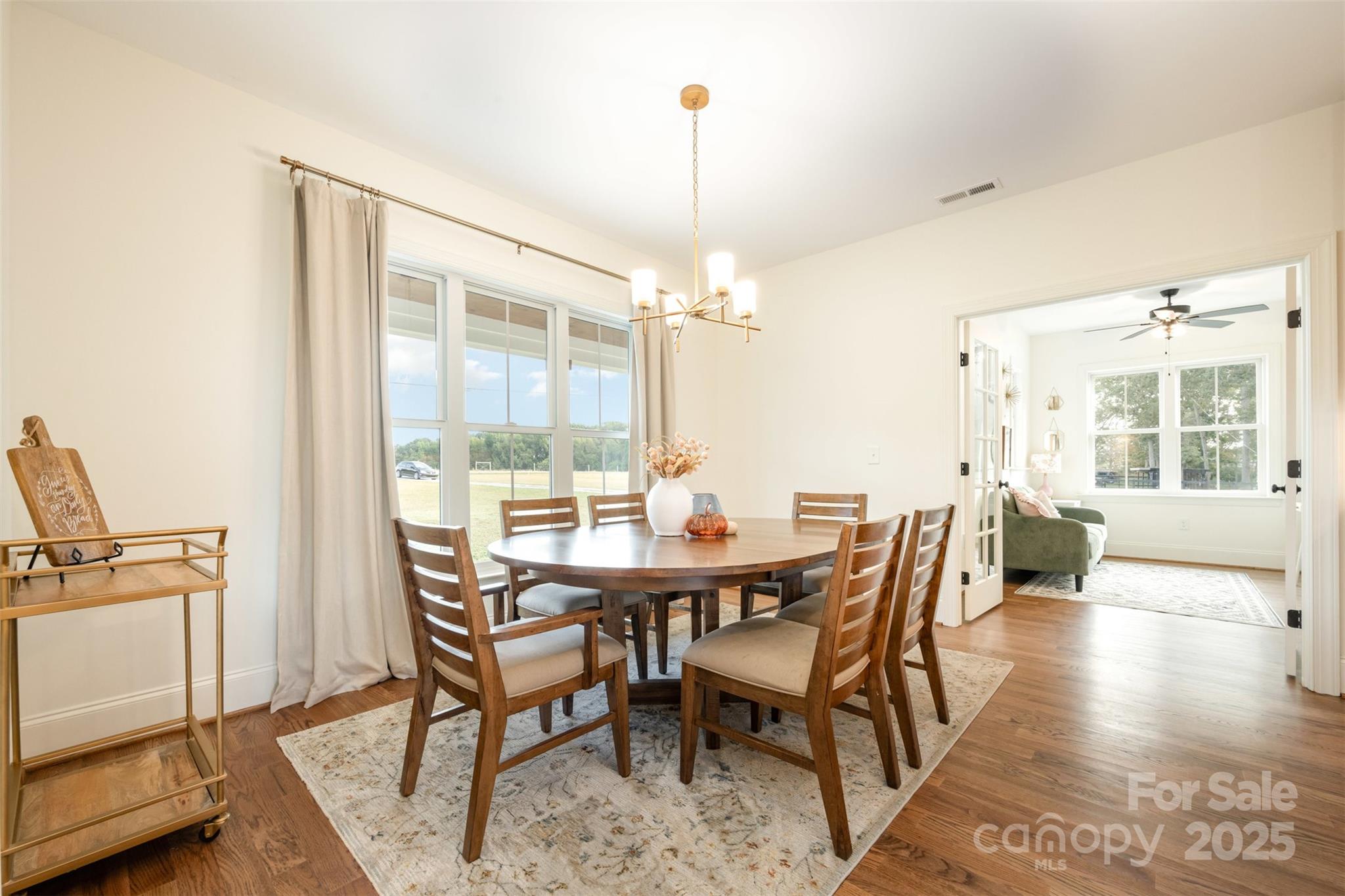 6322 Olive Branch Road Marshville, NC 28103 - Photo 5 of 28 a dining room with furniture a chandelier and wooden floor