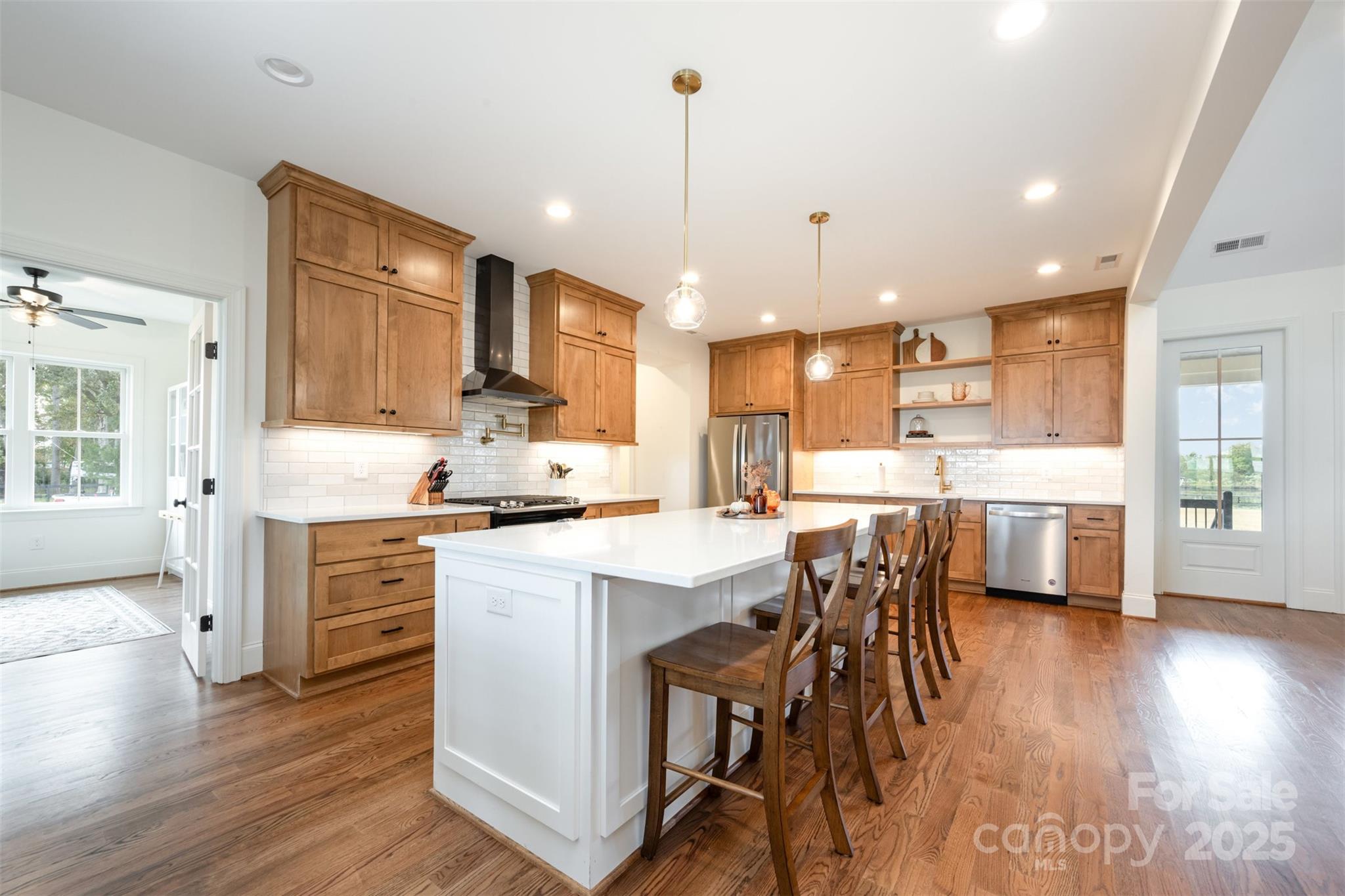 6322 Olive Branch Road Marshville, NC 28103 - Photo 6 of 28 a kitchen with a table chairs wooden floors and white cabinets