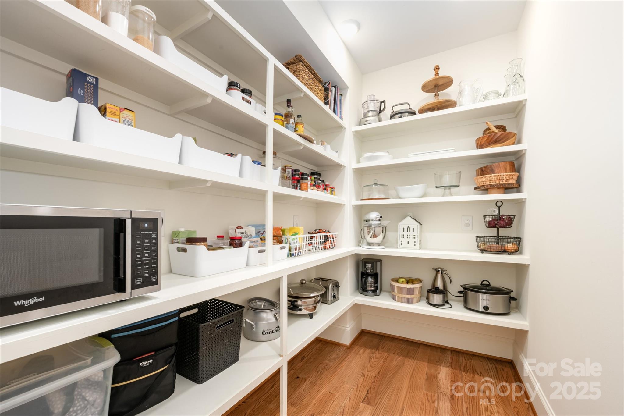6322 Olive Branch Road Marshville, NC 28103 - Photo 7 of 28 a kitchen with white cabinets and wooden floor