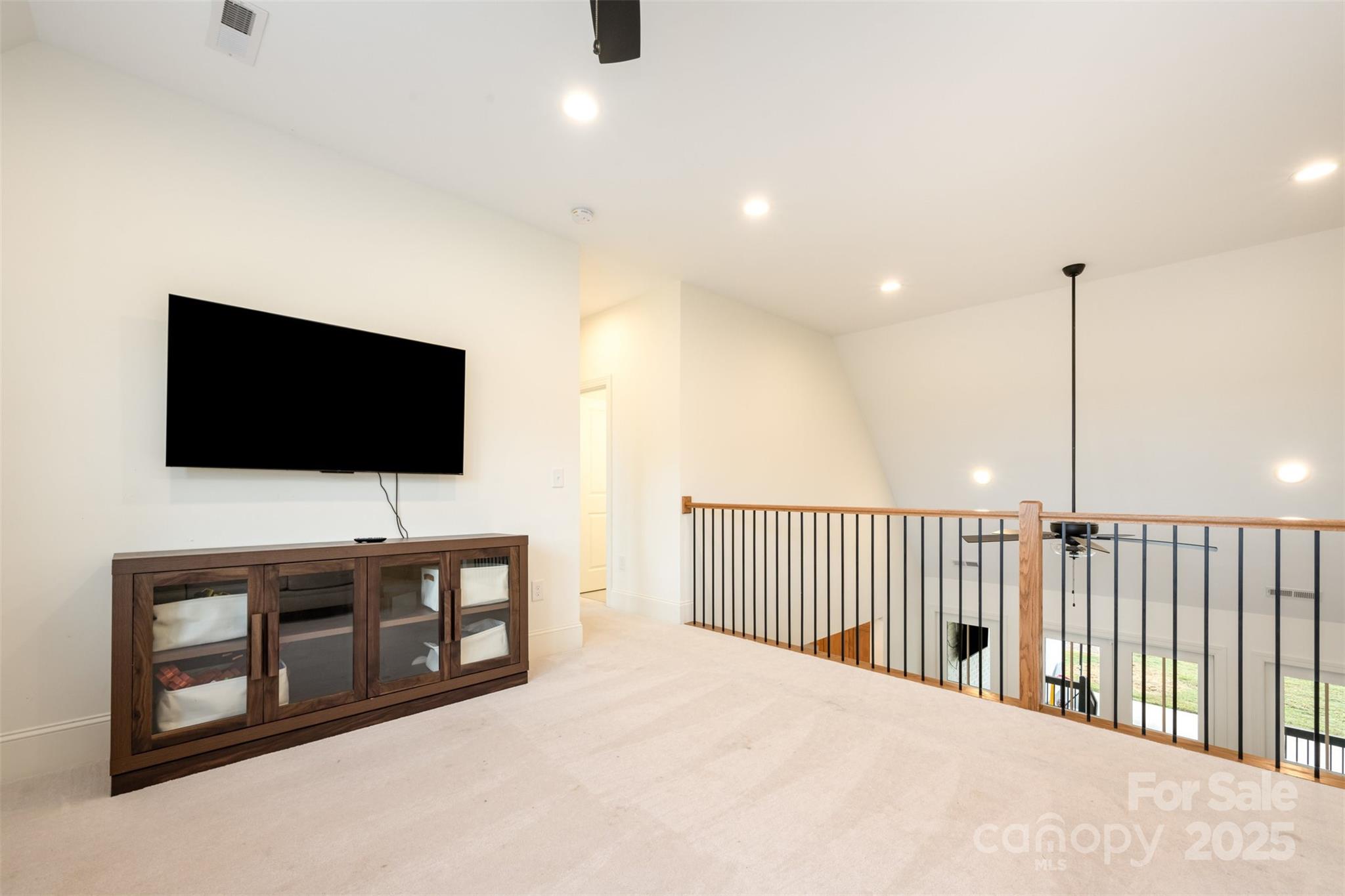 6322 Olive Branch Road Marshville, NC 28103 - Photo 9 of 28 a living room with flat screen tv and a ceiling fan