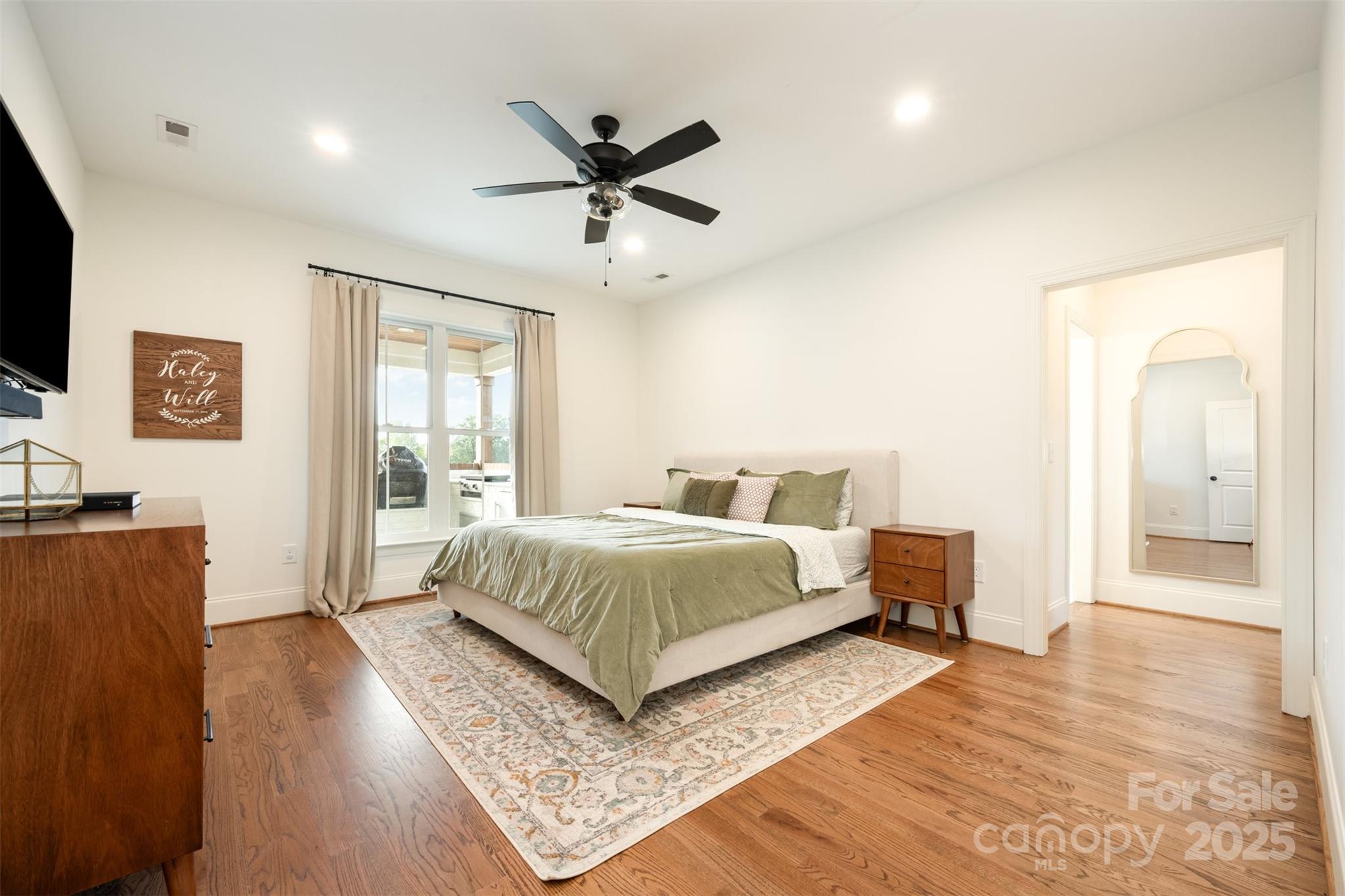 6322 Olive Branch Road Marshville, NC 28103 - Photo 10 of 28 a spacious bedroom with a bed and wooden floor