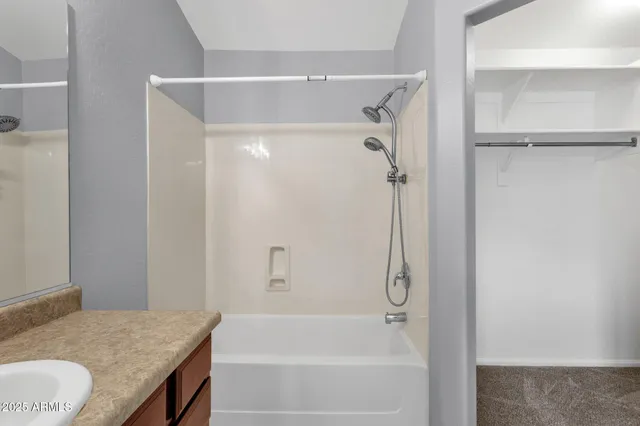 a bathroom with a granite countertop shower and a sink