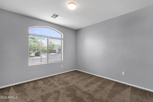 an empty room with a empty space and windows