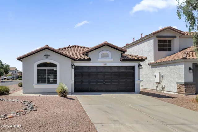 a front view of a house with a yard and garage