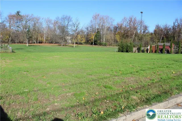 a view of a field of building and trees in the background