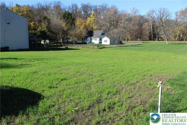 a view of a field of grass and trees
