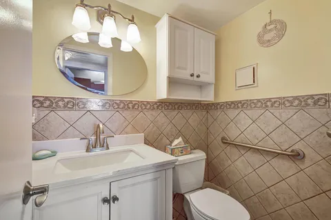 a bathroom with a sink mirror vanity and toilet