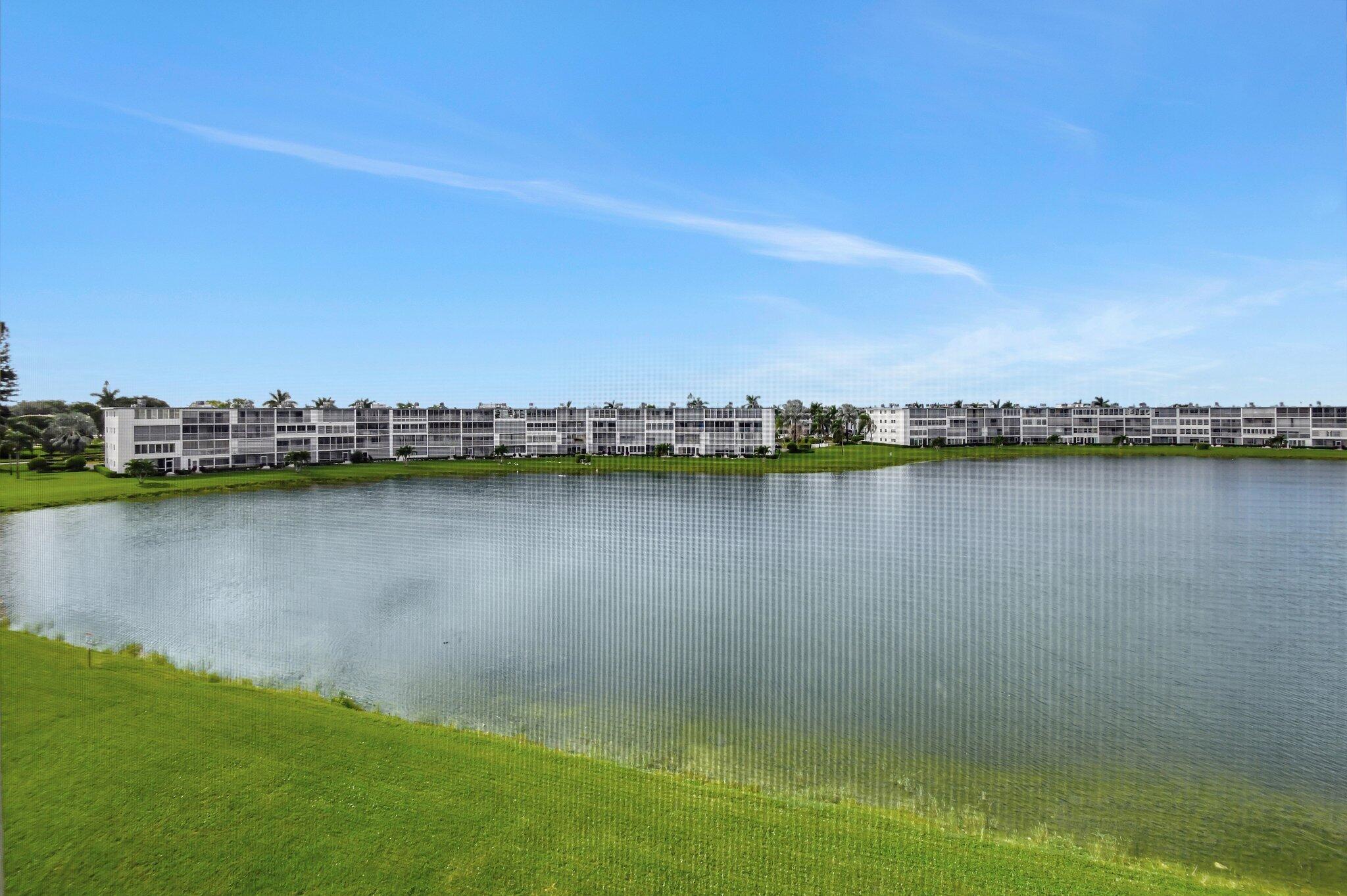 4089 Guildford East, Unit E Boca Raton, FL 33434 - Photo 3 of 22 a view of a lake with a city view