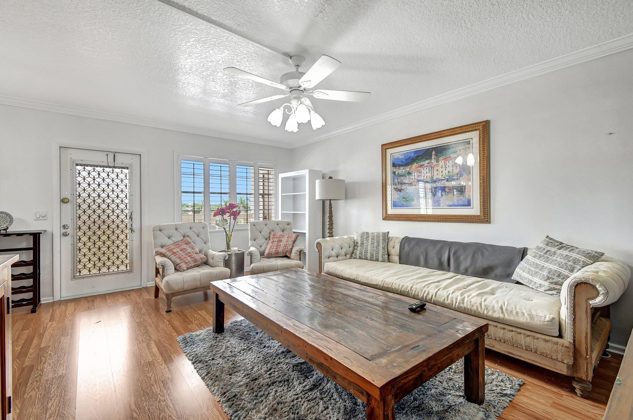 4089 Guildford East, Unit E Boca Raton, FL 33434 - Photo 4 of 22 a living room with furniture and wooden floor
