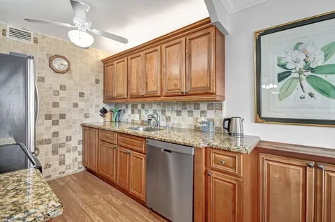 a kitchen with stainless steel appliances granite countertop a sink and dishwasher with cabinets