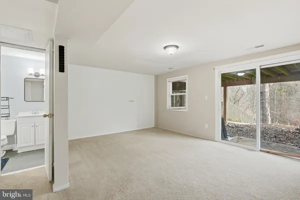 an empty room with sliding glass door and shower