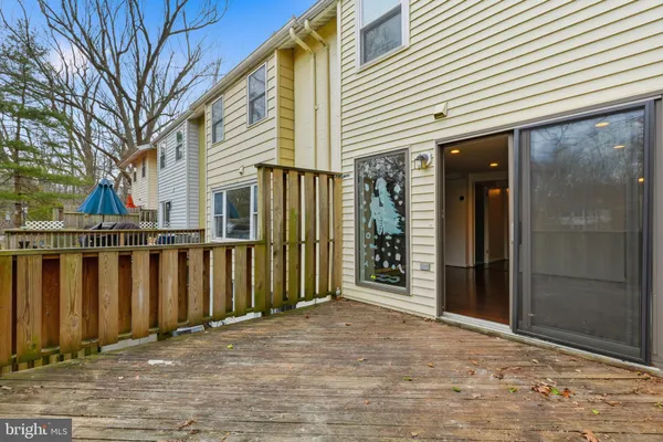 a view of a house with a wooden fence