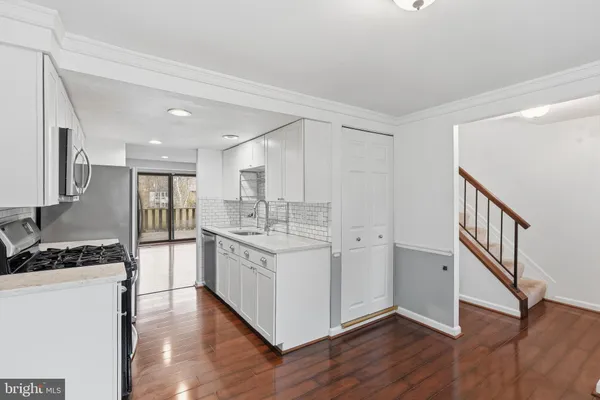 a kitchen with stainless steel appliances granite countertop a sink and a stove top oven