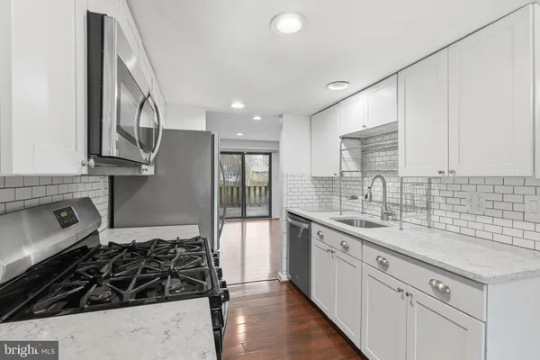 a kitchen with a sink stove and cabinets