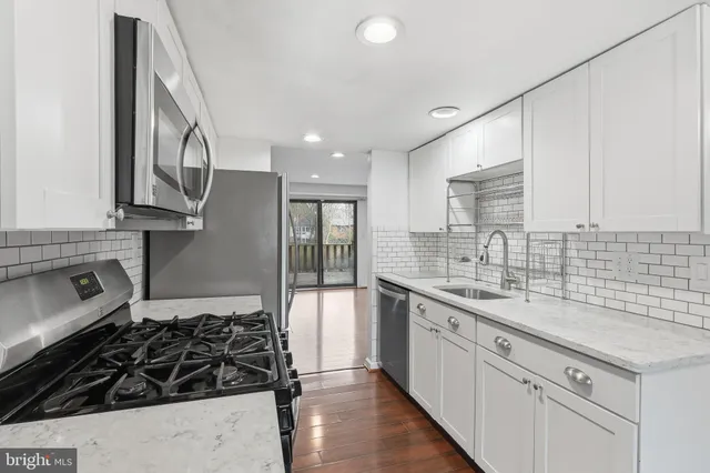 a kitchen with a sink stove and cabinets