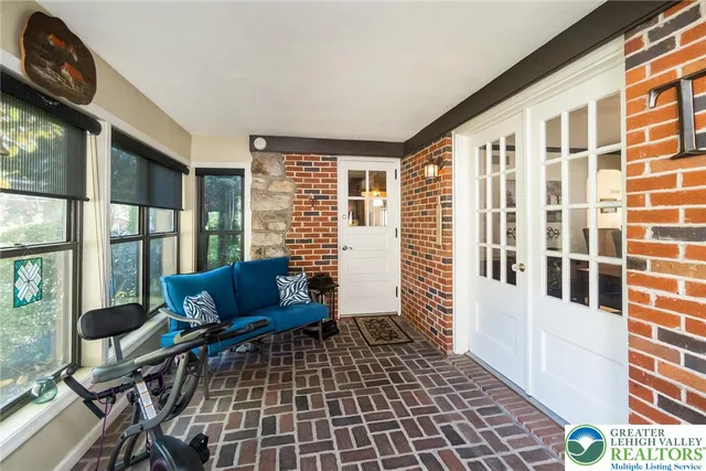 a living room with a black white checkered floor with a dining table and chairs