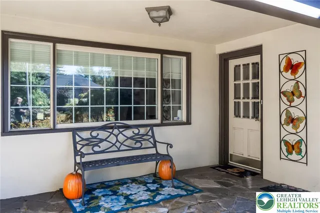 a front view of a house with a large window
