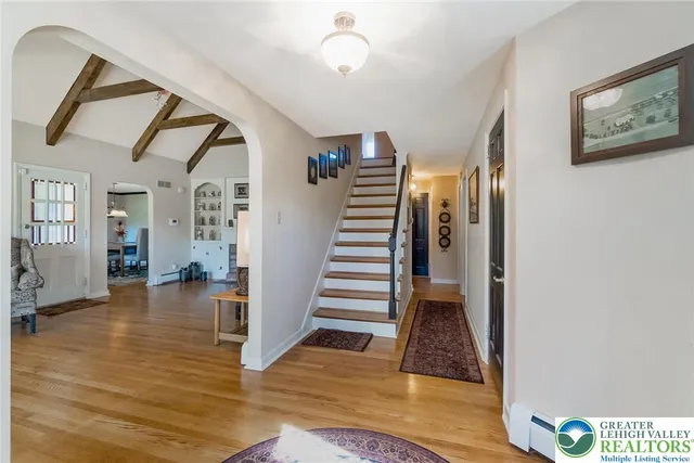 a view of entryway and hall with wooden floor