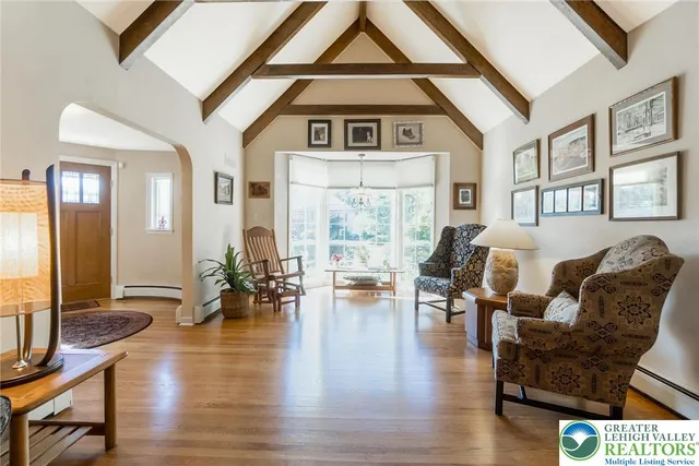 a living room with furniture and floor to ceiling windows