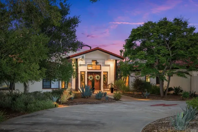 a view of a house with a yard and tree s