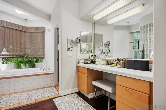 a bathroom with a bathtub and plant