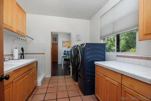 a work room with furniture a rug and a window