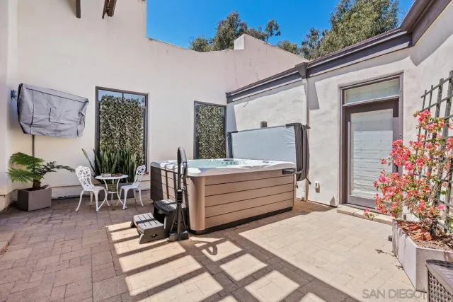a view of a patio with table and chairs under an umbrella