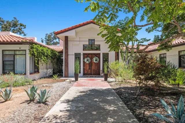 a front view of a house with garden