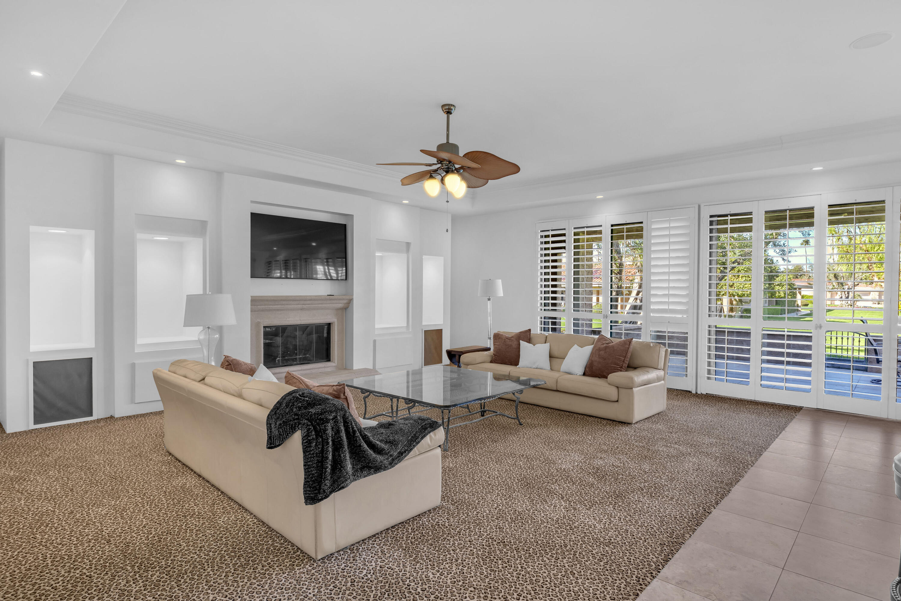 77690 Seminole Road Indian Wells, CA 92210 - Photo 16 of 59 a living room with furniture a fireplace and a flat screen tv
