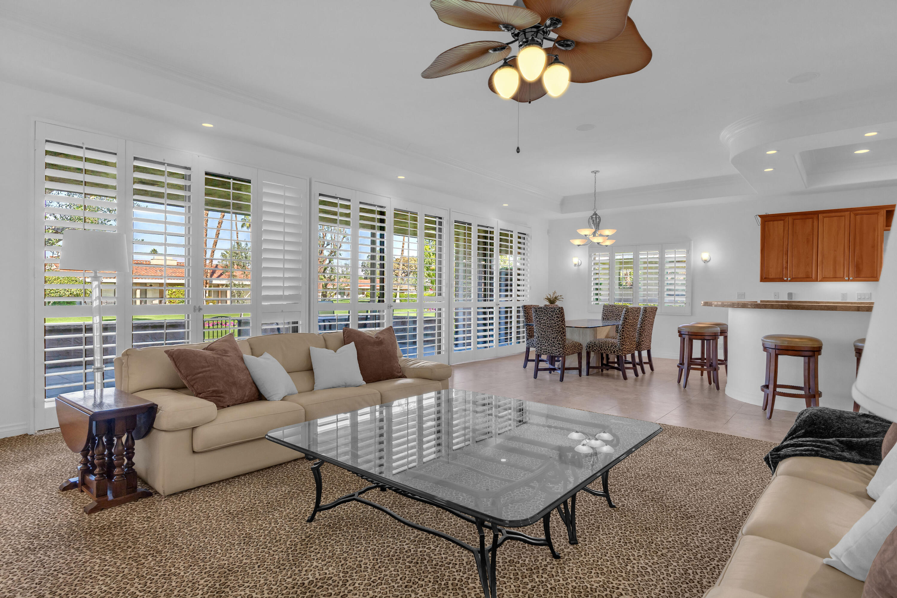 77690 Seminole Road Indian Wells, CA 92210 - Photo 22 of 59 a living room with furniture a dining table and a large window