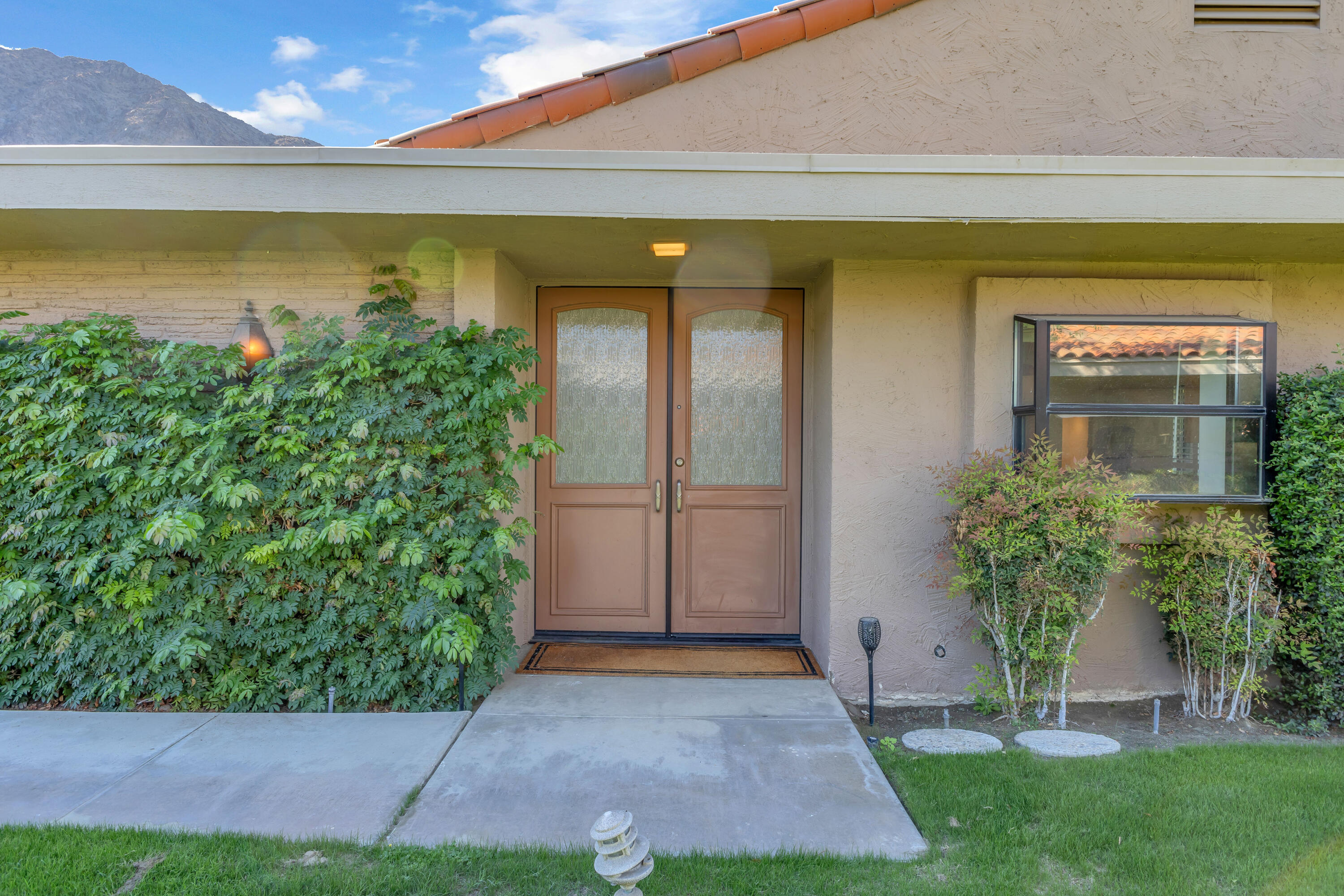 77690 Seminole Road Indian Wells, CA 92210 - Photo 3 of 59 a front view of a house with a yard