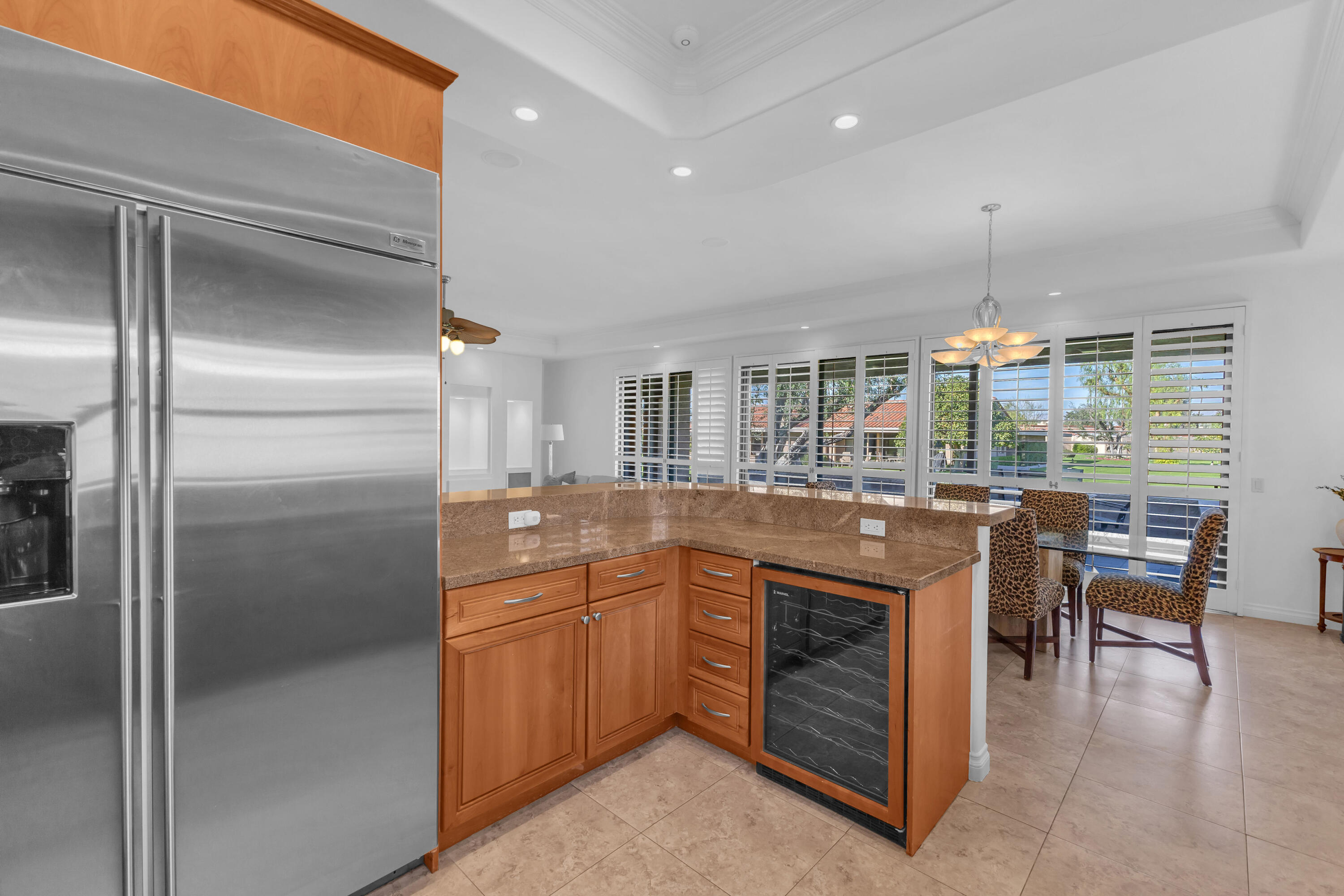 77690 Seminole Road Indian Wells, CA 92210 - Photo 32 of 59 a kitchen with kitchen island a sink stainless steel appliances and dining table