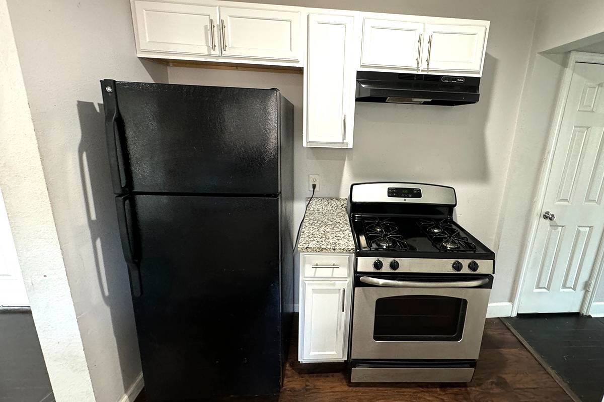 3420 Rosedale Street Houston, TX 77004 - Photo 14 of 19 a kitchen with a stove and a refrigerator
