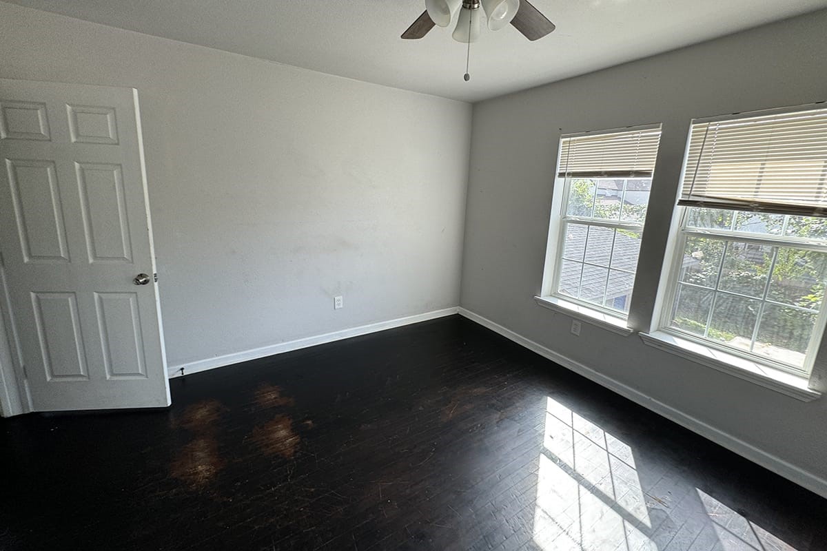 3420 Rosedale Street Houston, TX 77004 - Photo 17 of 19 an empty room with wooden floor and windows