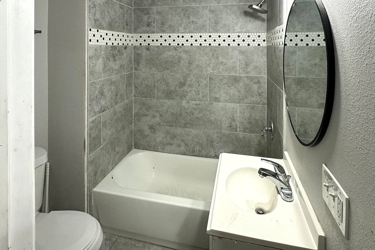 3420 Rosedale Street Houston, TX 77004 - Photo 18 of 19 a bathroom with a sink a toilet and shower