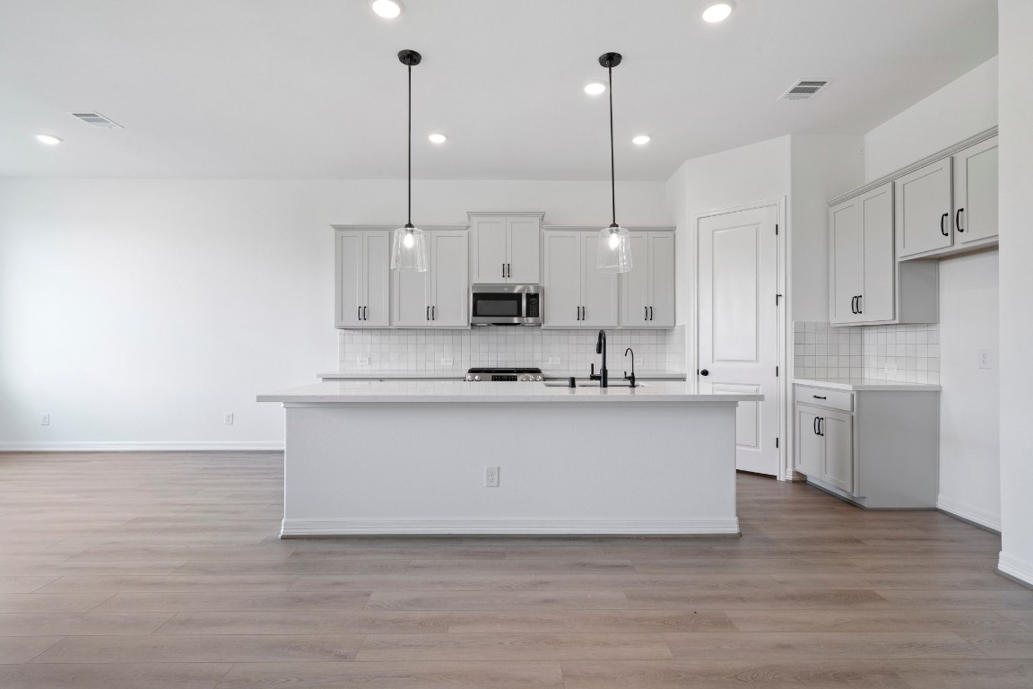 32107 Waterlily View Hockley, TX 77447 - Photo 2 of 21 a white kitchen with a sink and dishwasher